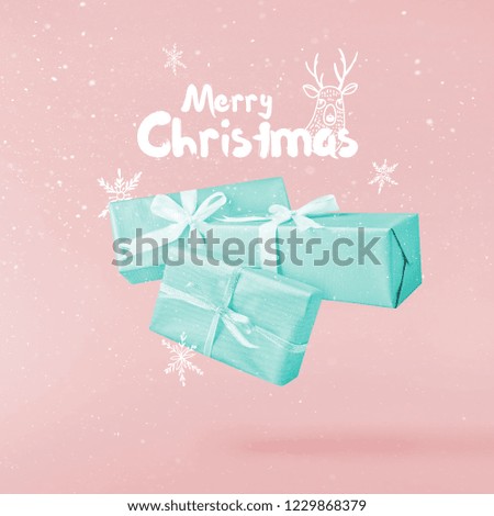 Christmas concept.  Creative Christmas conception made by falling in air gift box over pink background. Minimal concept