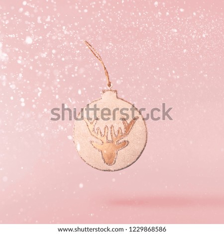 Christmas concept.  Creative Christmas conception made by falling in air christmas retro decoration over pink background. Minimal concept