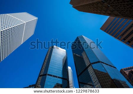 Looking Straight up rising Denver Skyscrapers and modern urban development Downtown Skyline Cityscape with perfect blue sky in the Mile High City in Denver , Colorado , USA