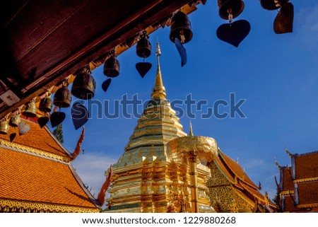 pagoda at wat phra that doi suthep, Chiang Mai, Thailand with little bell hanging on eaves foreground and blue sky background
