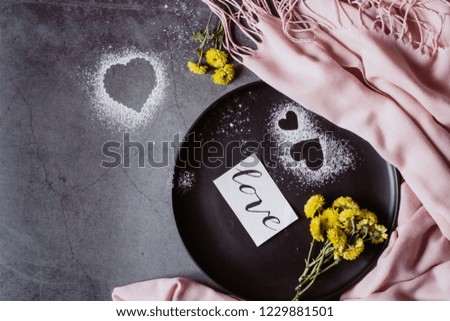 Holiday background. Scarf, flower and heart on gray table. Valentines and Mother's Day concept. Flat lay, top view, copy space