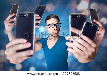 Influencer holding an exaggerated number of smartphones