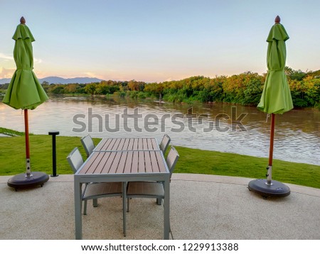Table and chairs placed in a resting. View rivers and mountains in the evening.