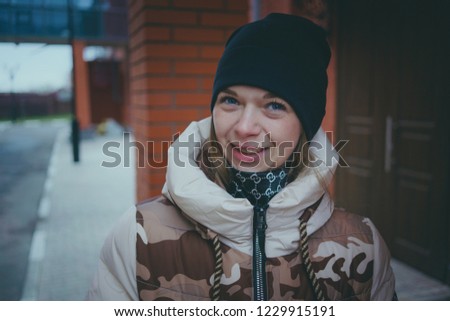 Girl posing on the street, a student in street clothes in the winter. street style. emotional portraits
