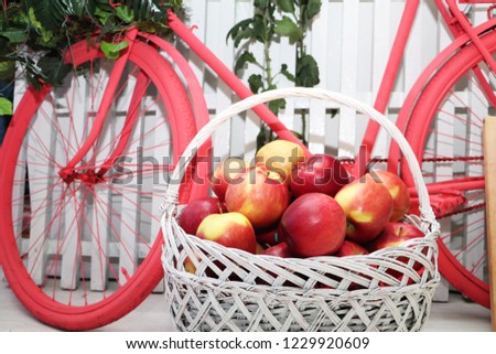 Basket with apples on the background of the bike. Studio decoration