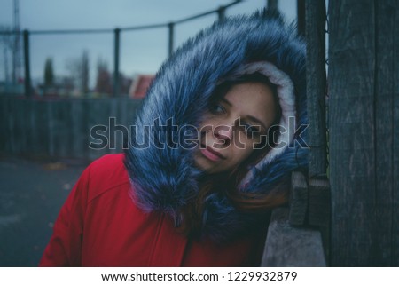 Girl posing on the street, a student in street clothes in the winter. street style. emotional portraits