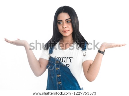 girl with blue and white dress poses in studio on white