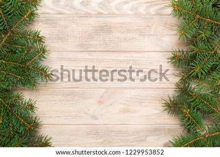 Christmas gray wooden background with fir tree and copy space. top view empty space for your design.