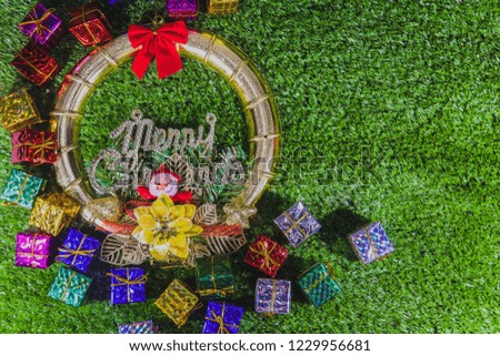 Merry Christmas! Happy Christmas Companions. Santa Claus and Gift Box Decorated on Green Field Background 