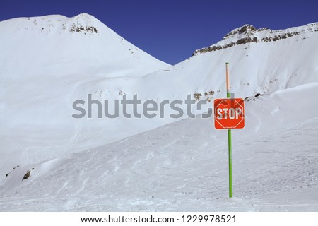 Marking of ski slopes. Closed slope with stop sign. Caucasus Mountains, Georgia, ski resort Gudauri.