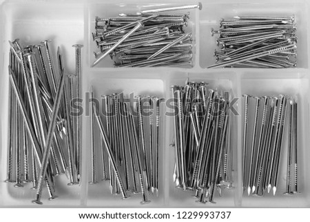 Close up of a bunch of nails in a nail box