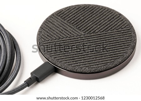 The wireless charger on a white background. New technology concept