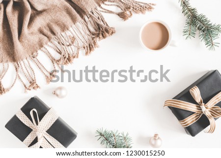 Christmas decorations, plaid, fir tree branch, gifts, cup of coffee on white background. Christmas, new year, winter concept. Flat lay, top view, copy space