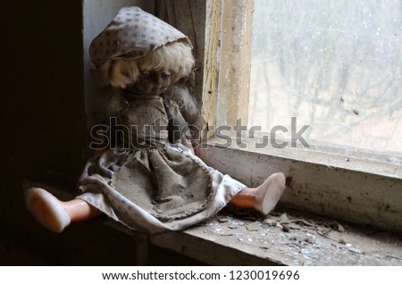 Doll on windowsill in abandoned kindergarten in destroyed village of Kopachi (10-km Chernobyl NPP alienation zone), Ukraine Royalty-Free Stock Photo #1230019696