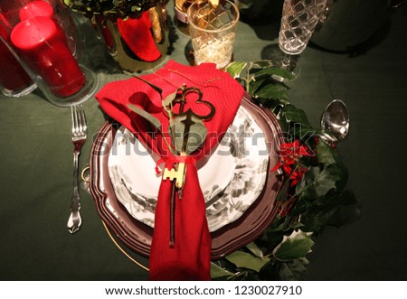 Christmas table setting - plate, cutlery, wineglass, candle with christmas decorations                               
