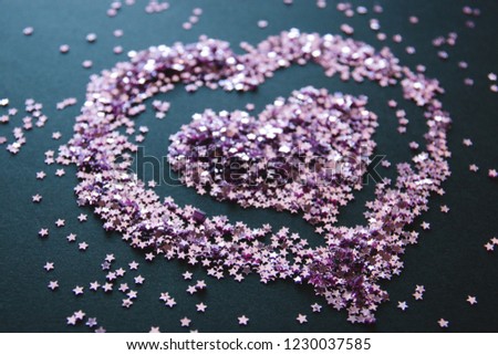 small loose glitter in the form of stars, glitter in the form of hearts, love background.