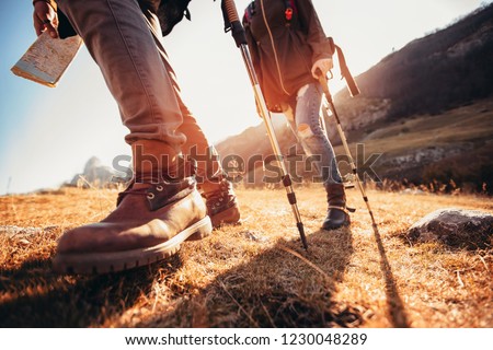 Hiking man and woman with trekking boots on the trail Royalty-Free Stock Photo #1230048289