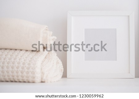 Towels and a frame with a place for an inscription on the shelf