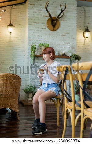 Asian woman in coffee shop. Asian woman is drinking ice coffee.