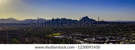 Aerial, drone, panoramic view over Fountain Hills Lake in Fountain Hills, Arizona with beautiful landscaped park area, clear, blue water and sky