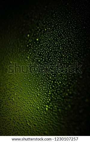 Green oval glass surface with beautiful green drops giving an appetizing appeal with mystic light. 