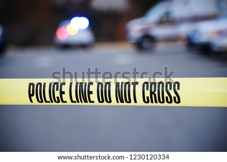 Crime Scene blocked off by law enforcement. Do not cross tape up marking the scene. Royalty-Free Stock Photo #1230120334