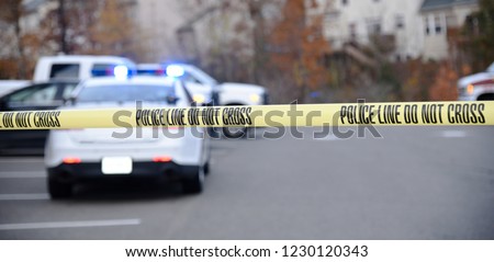 Crime Scene blocked off by law enforcement. Do not cross tape up marking the scene. Royalty-Free Stock Photo #1230120343
