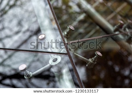 Fastening the glass construction of panoramic windows, close-up details of the construction of the glazing of the facade. Royalty-Free Stock Photo #1230133117