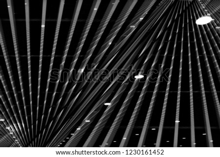Reworked photo of lath ceiling with spot lights. Abstract modern architecture or interior background in black and white with geometric structure.