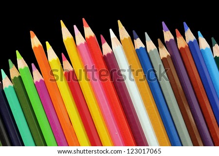 Set of color pencils isolated on a black background