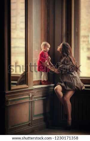 
Beautiful young woman with a child. Image with selective focus and toning.