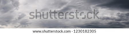 Dramatic sky dackground, stormy clouds in dark sky, panoramic view Royalty-Free Stock Photo #1230182305