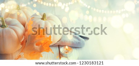 Thanksgiving Day dinner. Holiday served table decorated with pumpkins, autumn bright colorful leaves and burning cadles. Beautiful table setting, Thanksgiving backdrop, widescreen background