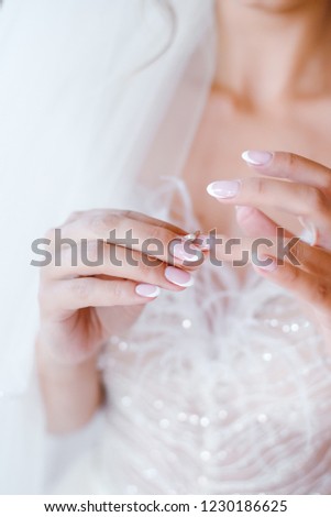 Beautiful woman putting on wedding golden ring. Close up womans hands