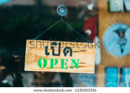 Welcome open sign on door of coffee cafe shop.