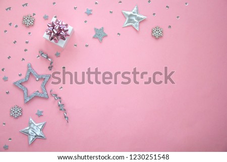 Silver sparkling christmas decoration on pastel pink background. Place for text. Festive concept. Concept of celebrating New year and Christmas. Flat lay style.