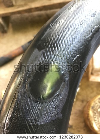 This picture is recap of motorcycle tire by cold patching use tire cover on tire.