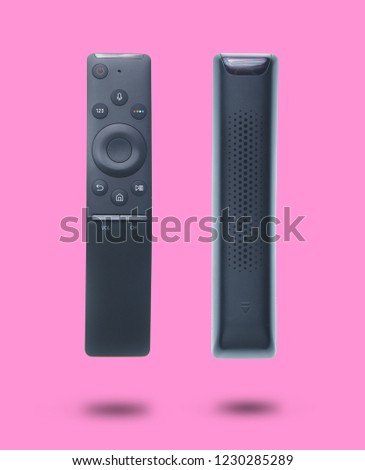 Modern tv remote isolated on pink background.Set of two different foreshortenings.