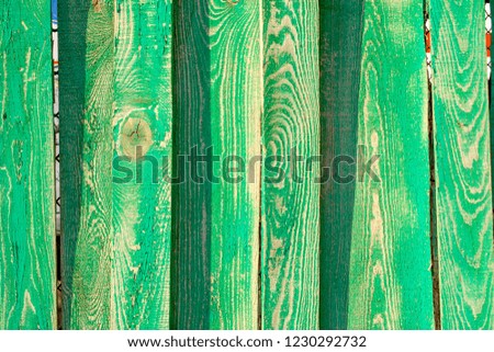 Beautiful background of green old fence, cracked paint, texture for design.