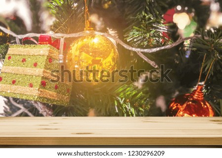 Wood table top with bokeh from decorative light on Christmas ball in background - can be used for display or montage your products