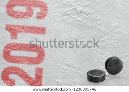 Two hockey pucks on the ice arena, season 2019. Concept, hockey, season