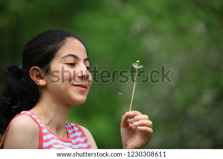 Pretty little girl blowing on a dandelion.turkey