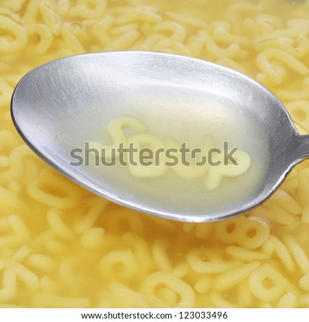 alphabet pasta letters forming word soup on a spoon