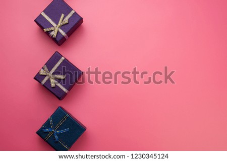 purple and blue christmas boxes on pink background. Web design. For the blog.