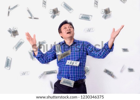 Portrait of a very happy young businessman in a rain of money on white background