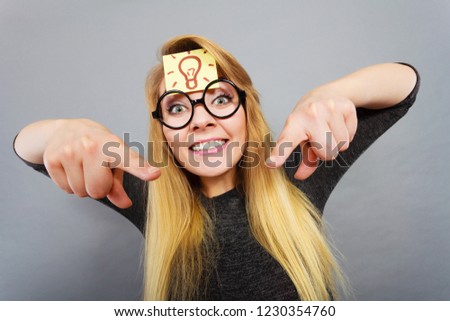 Intellectual expressions, being focused concept. Woman wearing weird nerd eyeglasses having light bulb mark on forehead thinking about something, having great idea or solution