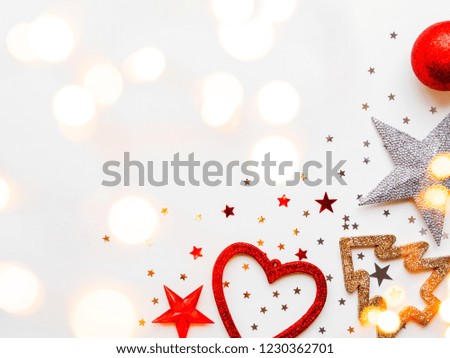 Christmas and New Year background with decorations - shiny stars, balls, snowflakes, heart, confetti and light bulbs. Place for text.