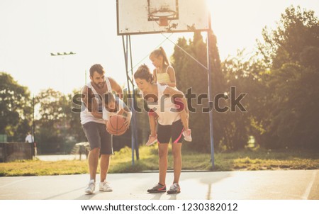  The moment of play and laughter. Family playing basketball.