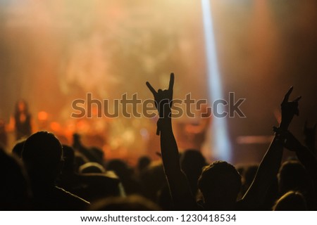 Hand raised showing a heavy metal rock sign, devil horns
