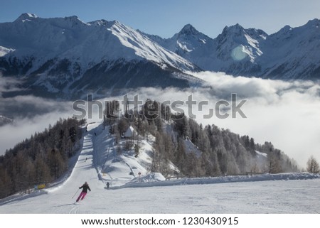 Matrei in Osttirol, Grossglockner Resort, Austria. Snowy ski slope. Skiers on the slope. Mountains in the background. Royalty-Free Stock Photo #1230430915